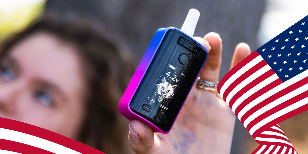 Hand holding a Wulf UNI 3.0 Vaporizer with an American flag in the background